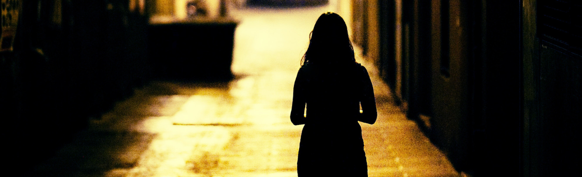 woman walking in alley at dark