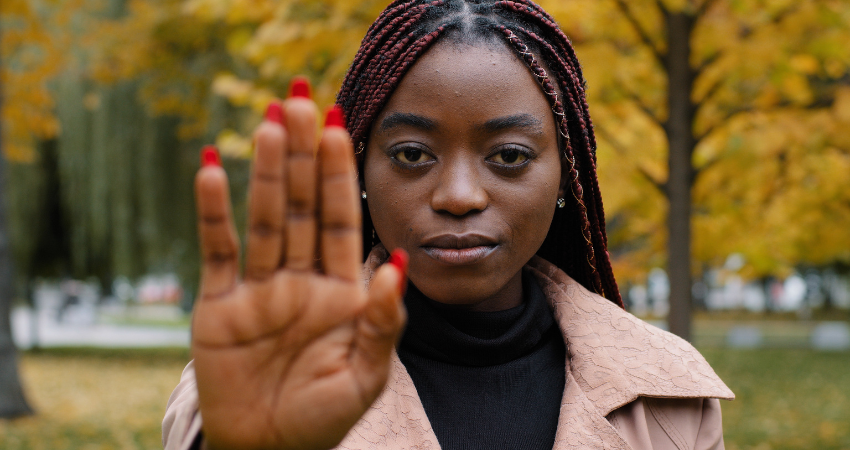 woman holding up stop hand